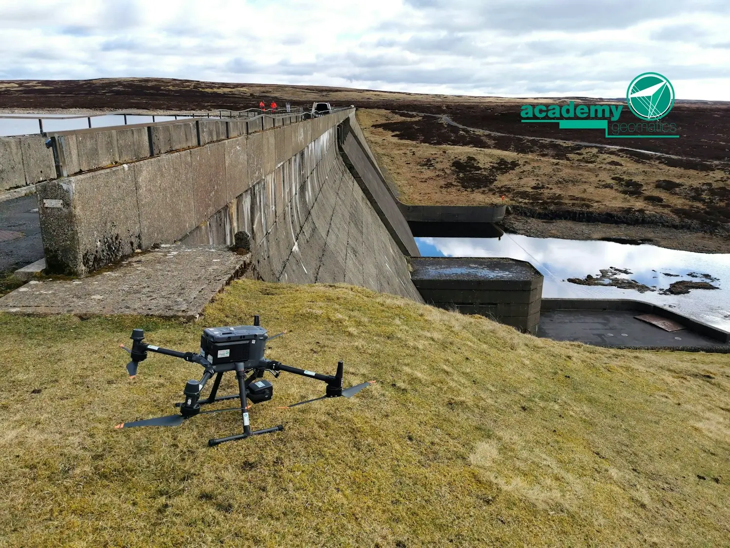 A drone preparing to take off next to a dam.