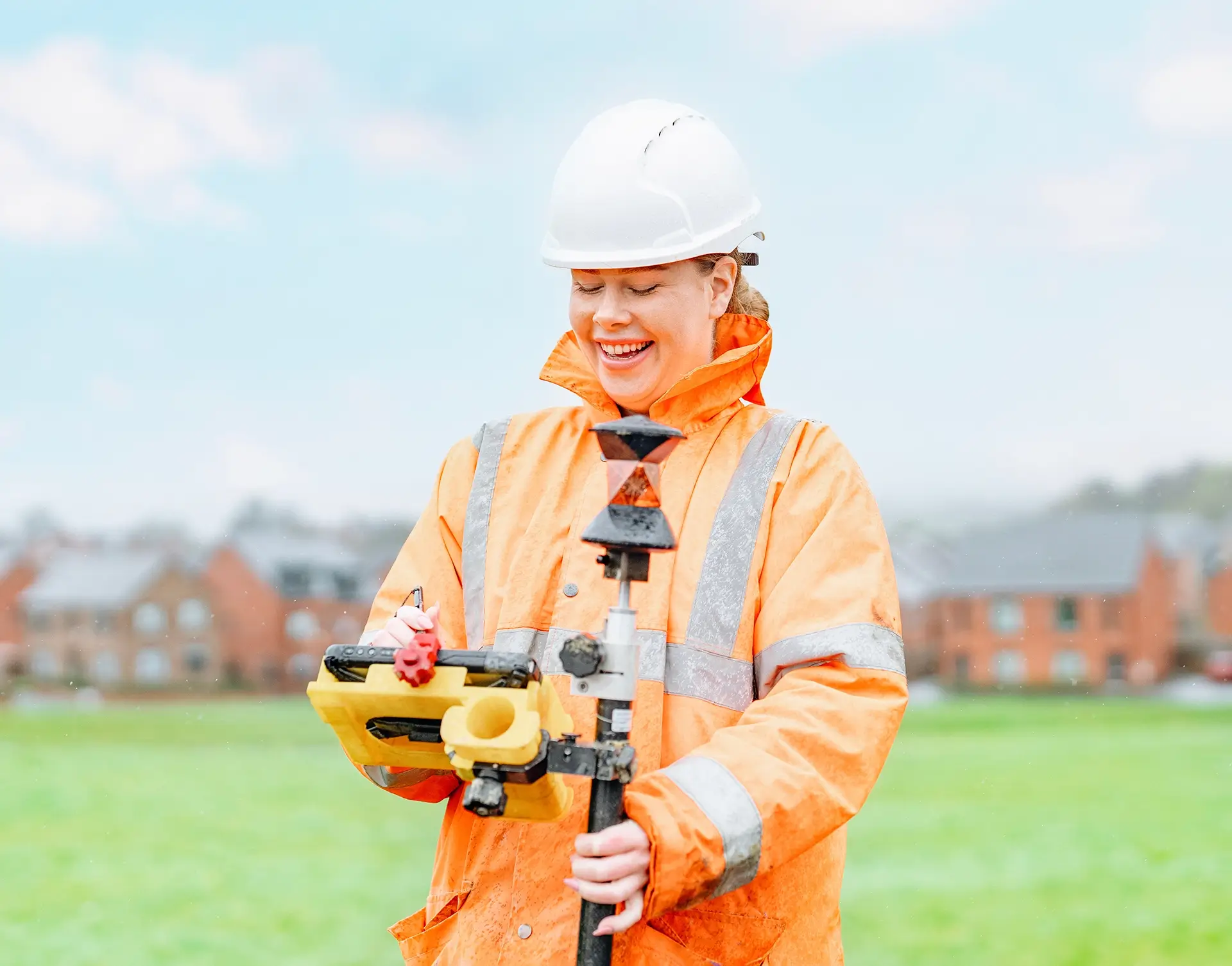Surveyor laughing whilst using a touchscreen tablet.
