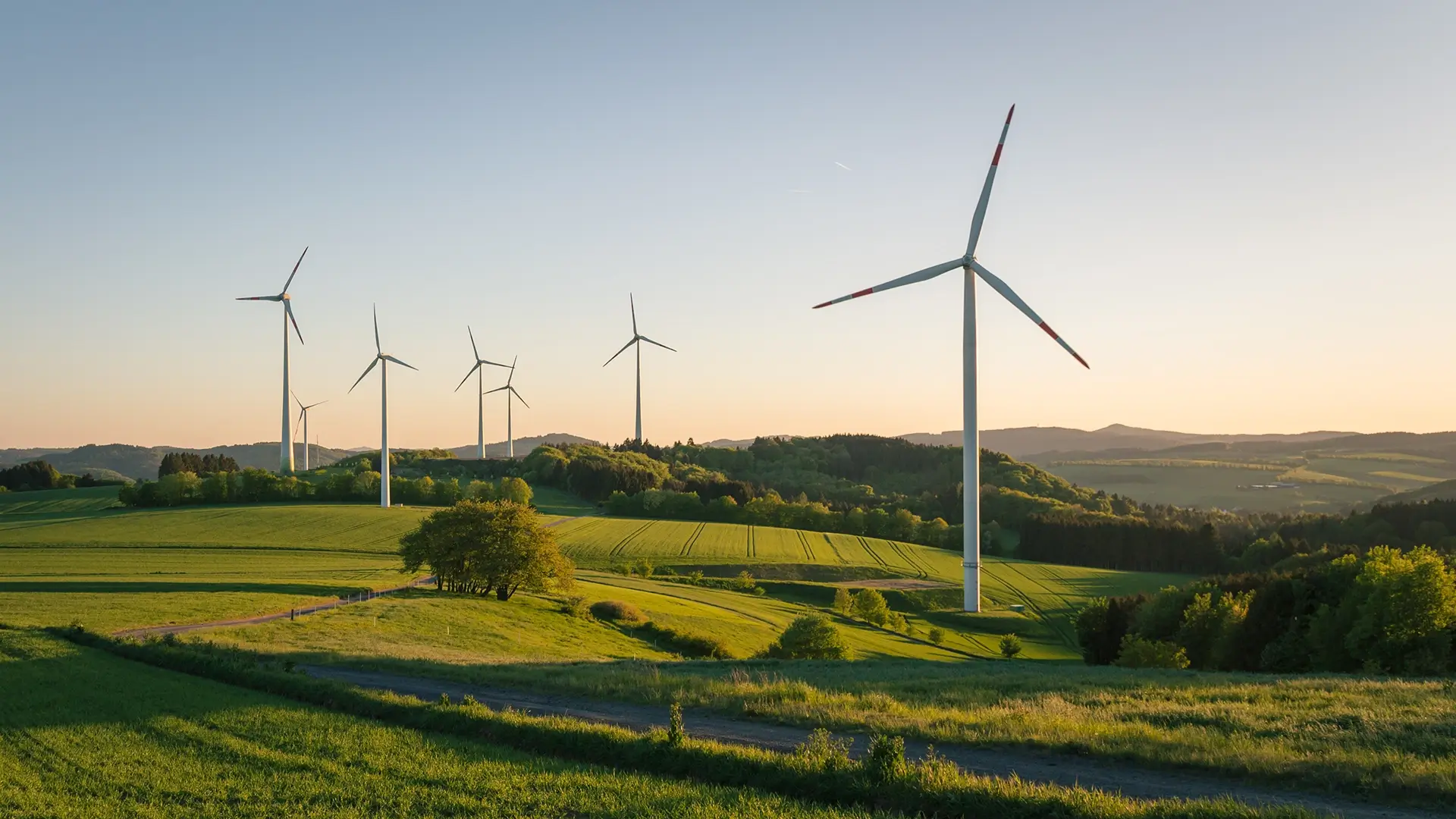 Wind turbines at sunrise in the middle of the countryside.