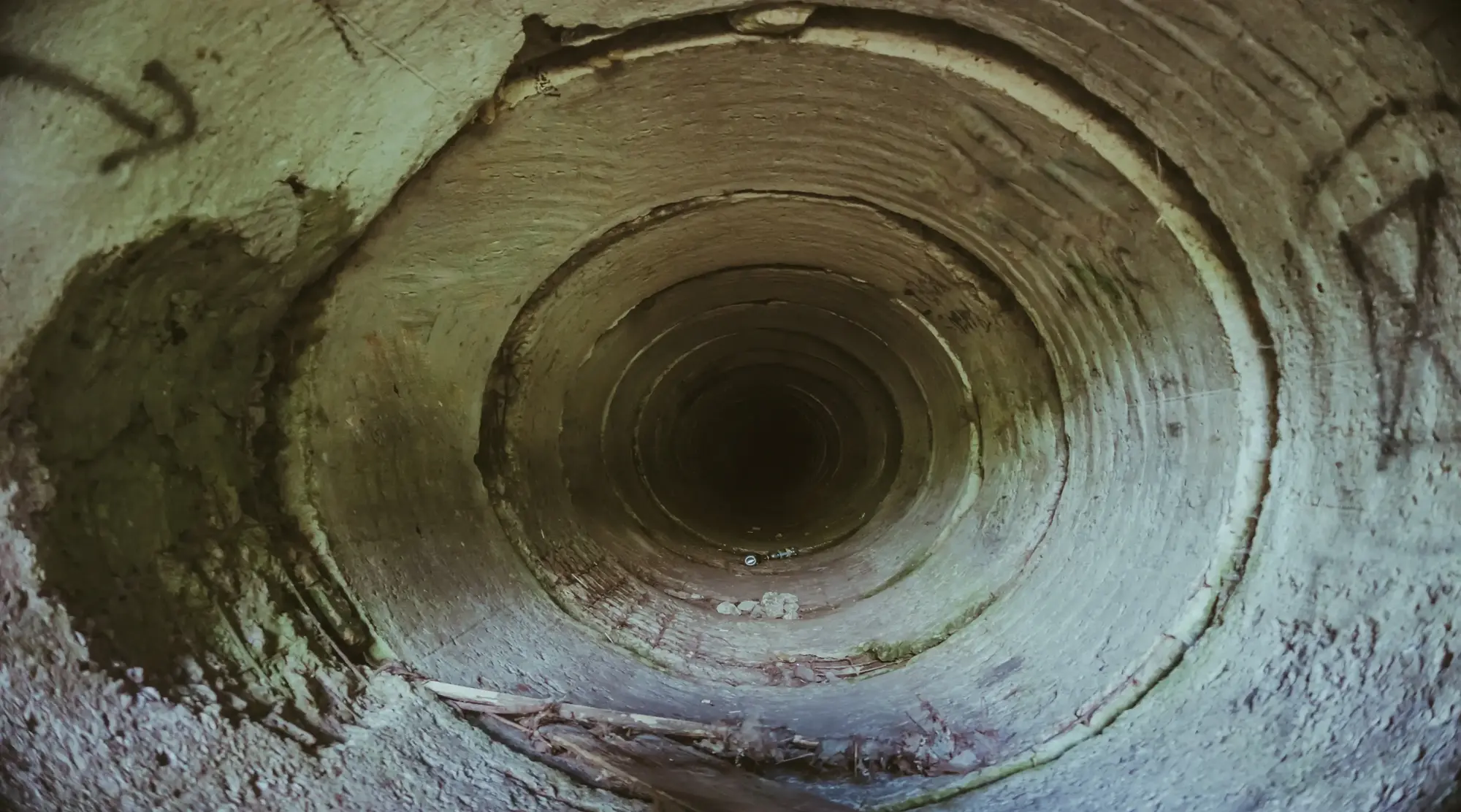 Inside an underground sewage pipe tunnel without water.