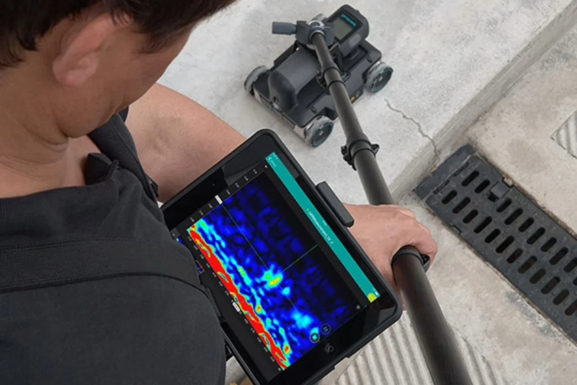 A man carries out a Ground Penetrating Radar survey.
