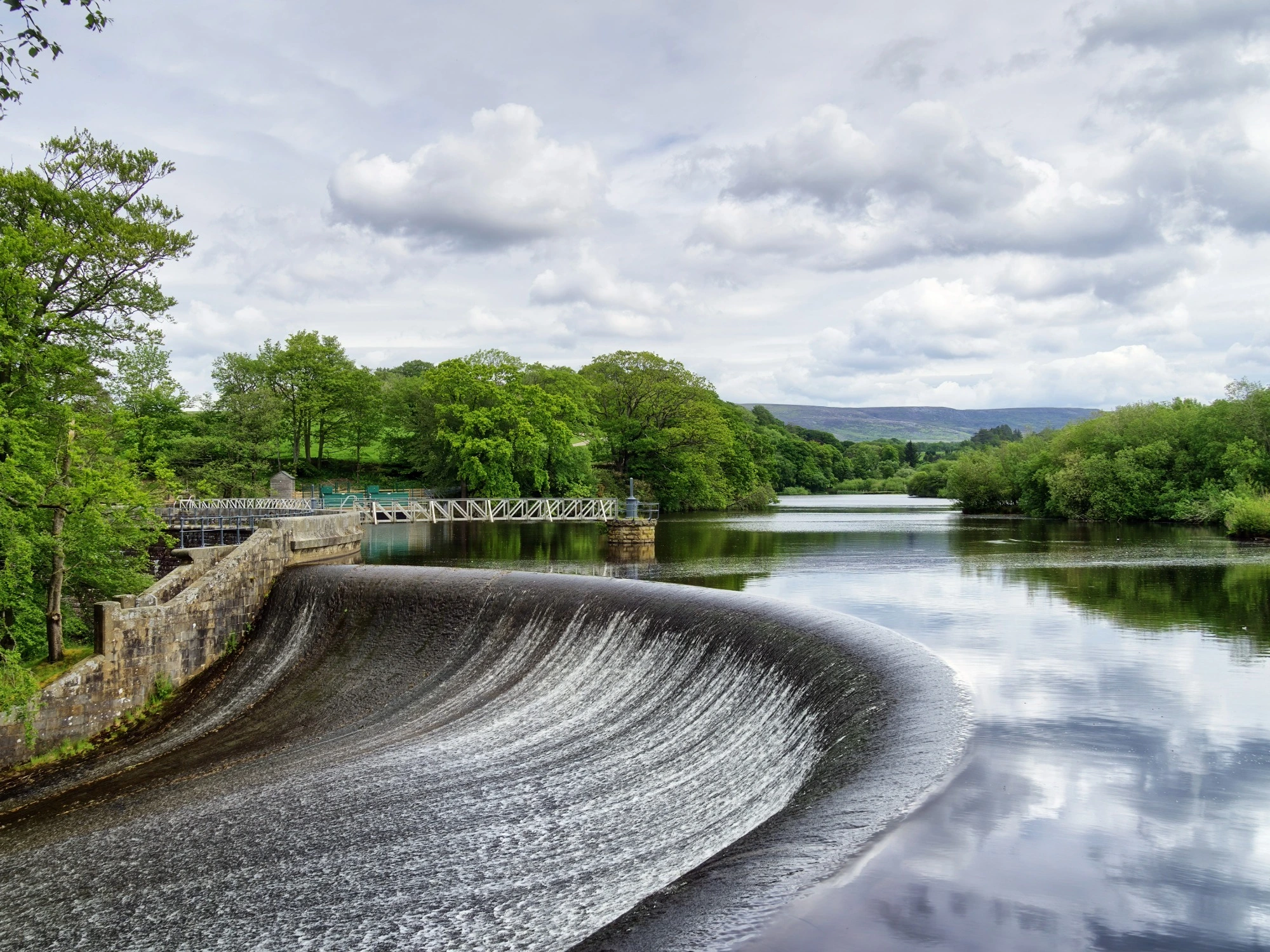 A forest reservoir and man-made dam.