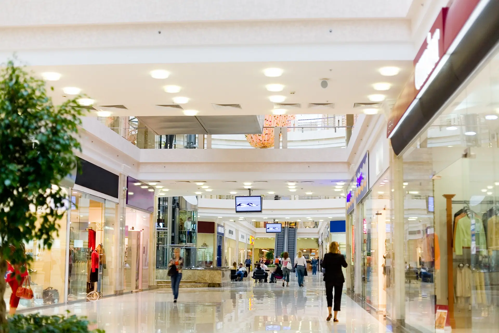 A busy shopping centre with multiple floors of shops.