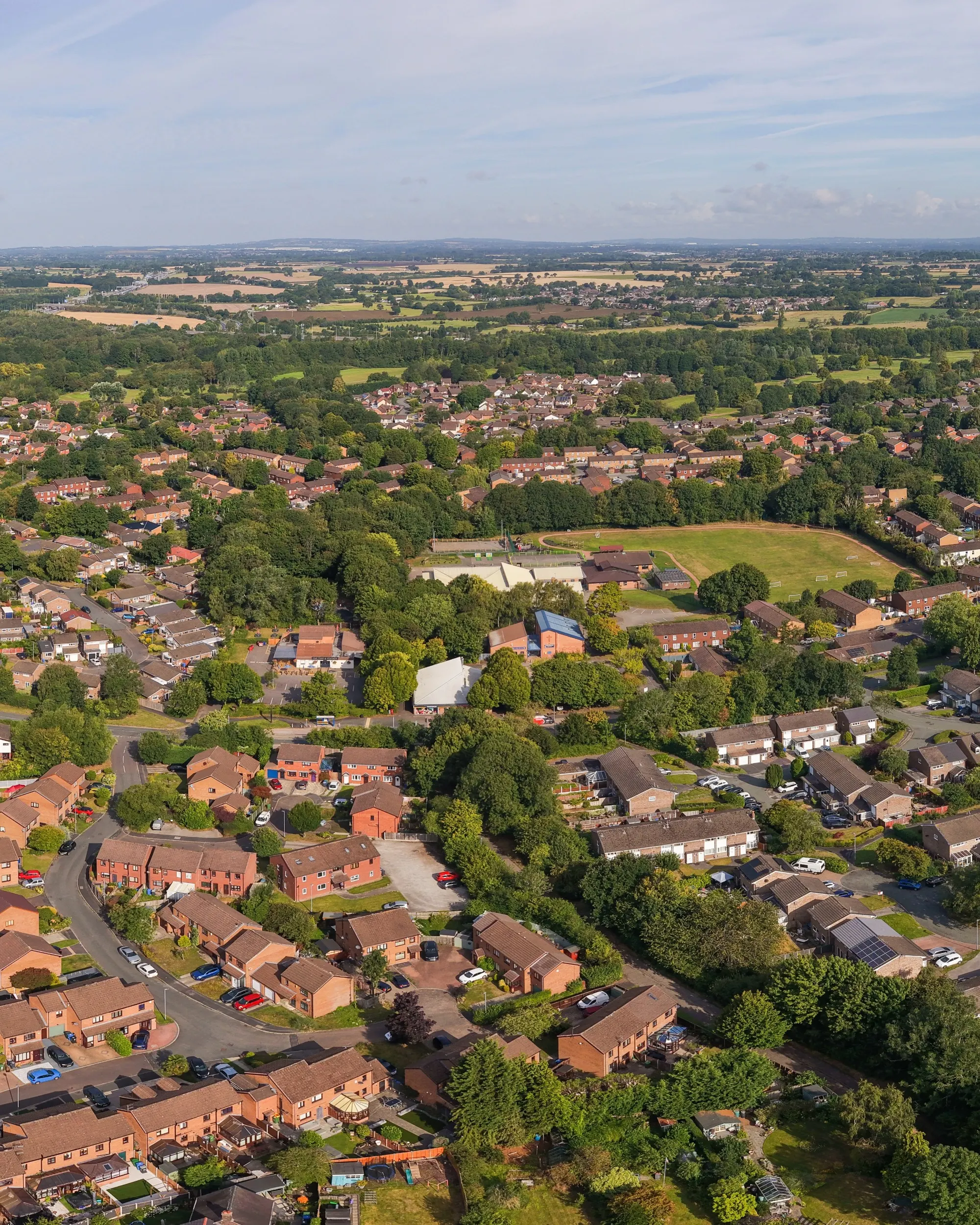 An aerial panoramic view of Birchwood village in Warrington, showcasing a mix of residential neighbourhoods and green spaces.